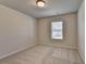 This bedroom has neutral walls and carpet and a window for natural light at 4250 Pembia Dr, Cumming, GA 30028