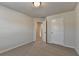 This bedroom features carpet and neutral walls with two doors, one to the hall and one to a closet at 4250 Pembia Dr, Cumming, GA 30028
