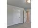 This bedroom features neutral walls, carpeted floors, and two paneled doors at 4250 Pembia Dr, Cumming, GA 30028