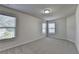 Bright bedroom featuring carpet floors and large windows providing natural light at 4250 Pembia Dr, Cumming, GA 30028