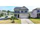 Two-story home with a gray and white facade, black shutters, and a two-car garage at 4250 Pembia Dr, Cumming, GA 30028