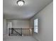 Upstairs hallway with wooden railing and natural light from a window at 4250 Pembia Dr, Cumming, GA 30028