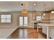 Bright, open kitchen with a granite countertop island, stainless steel appliances, and white cabinetry at 4250 Pembia Dr, Cumming, GA 30028