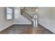 Open living room area featuring hardwood floors, staircase access, and a seamless flow to other living spaces within the home at 4250 Pembia Dr, Cumming, GA 30028