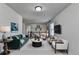 Upstairs living room with modern décor, including a sofa, chairs, and mounted TV at 4250 Pembia Dr, Cumming, GA 30028