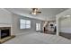 Open floorplan featuring a living room with a fireplace which leads to a modern kitchen at 4250 Pembia Dr, Cumming, GA 30028