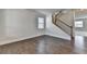 Spacious living room with hardwood floors, staircase, and ample natural light creating a bright and inviting atmosphere for residents at 4250 Pembia Dr, Cumming, GA 30028