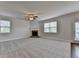 Bright living room featuring neutral colors, carpet floors, fireplace, and natural light at 4250 Pembia Dr, Cumming, GA 30028