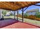 View of the shaded patio that offers brick flooring and a view of the fenced-in backyard at 4250 Pembia Dr, Cumming, GA 30028