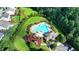 Aerial shot of a community pool surrounded by lush landscaping and mature trees, with ample lounging space at 4250 Pembia Dr, Cumming, GA 30028