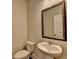 Updated powder room featuring a pedestal sink, toilet, framed mirror, and neutral paint at 4250 Pembia Dr, Cumming, GA 30028