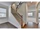 Elegant staircase with dark iron balusters, hardwood accents, and seamless transition between floors for functional and stylish living at 4250 Pembia Dr, Cumming, GA 30028