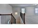 Staircase with a black iron railing leading into a carpeted second floor at 4250 Pembia Dr, Cumming, GA 30028