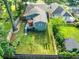 Aerial shot of the backyard featuring a spacious lawn, deck with umbrella, and secure fencing at 853 Gaston Sw St, Atlanta, GA 30310