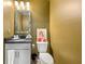 Charming powder room with a decorative mirror, framed print, and traditional fixtures and tiling at 853 Gaston Sw St, Atlanta, GA 30310