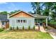 Inviting bungalow featuring a wood-shingled roof, grassy front yard, and charming front porch at 853 Gaston Sw St, Atlanta, GA 30310
