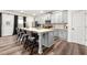 A modern kitchen with a large island, gray cabinets, stainless steel appliances, and wood flooring at 853 Gaston Sw St, Atlanta, GA 30310