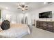 Spacious and serene primary bedroom with stylish accents, plush carpeting, and a mounted tv at 853 Gaston Sw St, Atlanta, GA 30310