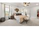 Spacious and serene primary bedroom with stylish accents, plush carpeting, and large windows at 853 Gaston Sw St, Atlanta, GA 30310