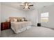 Bright main bedroom with a ceiling fan, plush carpet, and a large window providing natural light at 853 Gaston Sw St, Atlanta, GA 30310