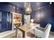 Navy blue office features a wooden desk, hutch, and an accent lamp atop an oriental style rug at 853 Gaston Sw St, Atlanta, GA 30310