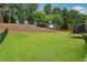 The backyard features a lush green lawn, mature trees and plenty of open space at 2009 Mclain Nw Rd, Acworth, GA 30101