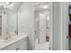 Bathroom featuring a white vanity, mirror, and a view into the shower at 2009 Mclain Nw Rd, Acworth, GA 30101
