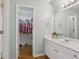 Bathroom featuring a white vanity, mirror, and a view into the closet at 2009 Mclain Nw Rd, Acworth, GA 30101