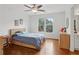 Bedroom features include hardwood floors, ceiling fan, and natural light from the window at 2009 Mclain Nw Rd, Acworth, GA 30101