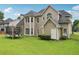 A spacious backyard with a lush lawn and mature trees offers plenty of room for recreation at 2009 Mclain Nw Rd, Acworth, GA 30101