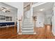 Spacious foyer with hardwood floors, a staircase with carpet runner, and views into adjacent living areas at 2009 Mclain Nw Rd, Acworth, GA 30101