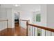 Bright hallway with hardwood floors, white walls, and a decorative chandelier at 2009 Mclain Nw Rd, Acworth, GA 30101
