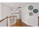 Hallway with hardwood floors, white walls, and decorative wall art at 2009 Mclain Nw Rd, Acworth, GA 30101