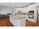 Kitchen island features granite countertop and white cabinets with stainless steel appliances at 2009 Mclain Nw Rd, Acworth, GA 30101