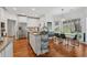 Bright eat-in kitchen features hardwood floors, white cabinetry, granite counters, and stainless steel appliances at 2009 Mclain Nw Rd, Acworth, GA 30101