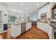 Open-concept kitchen with granite island, stainless steel appliances, and hardwood floors at 2009 Mclain Nw Rd, Acworth, GA 30101