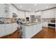 Spacious kitchen with white cabinets, granite countertops, stainless steel appliances, and a center island at 2009 Mclain Nw Rd, Acworth, GA 30101