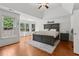 Spacious primary bedroom featuring tray ceilings, a sitting area, and hardwood floors at 2009 Mclain Nw Rd, Acworth, GA 30101