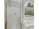 An expansive primary bathroom features a soaking tub, a glass shower, and an arched window at 2009 Mclain Nw Rd, Acworth, GA 30101