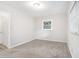 Bright bedroom featuring neutral walls, carpet, a window, and a ceiling light at 2721 Glenvalley Dr, Decatur, GA 30032