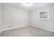 Bright carpeted bedroom featuring neutral walls and a window for natural light at 2721 Glenvalley Dr, Decatur, GA 30032