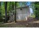 View of the back of the house with brick siding, surrounded by lush greenery at 2721 Glenvalley Dr, Decatur, GA 30032