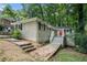 Home with a red door, stairs to the entrance, and lots of surrounding trees at 2721 Glenvalley Dr, Decatur, GA 30032