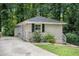 Ranch-style home surrounded by lush trees and features grey brick at 2721 Glenvalley Dr, Decatur, GA 30032