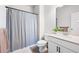 Clean bathroom featuring a shower-tub combo, sleek vanity, and modern fixtures at 320 Crider Ct, Woodstock, GA 30188