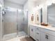 Bright bathroom featuring a glass shower, double sink vanity, and modern fixtures at 320 Crider Ct, Woodstock, GA 30188