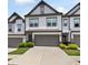 Charming townhome featuring a two-car garage and well-maintained landscaping at 320 Crider Ct, Woodstock, GA 30188