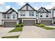 Beautiful townhome with a grey two-car garage, well-kept lawn, and attractive curb appeal at 320 Crider Ct, Woodstock, GA 30188