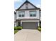 The exterior features a two-car garage and manicured landscaping at 320 Crider Ct, Woodstock, GA 30188