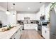 Contemporary kitchen with stainless steel appliances, granite counters, and sleek white cabinetry at 320 Crider Ct, Woodstock, GA 30188